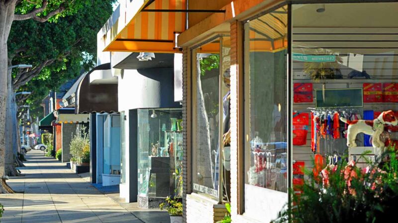Street view of retail shops, representing the need for business insurance coverage for small retail operations.